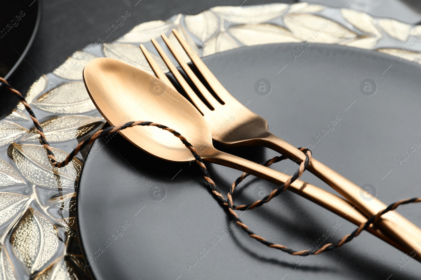 Photo of Stylish table setting with golden cutlery, closeup