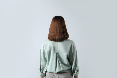 Photo of Girl wearing blouse on white background, back view