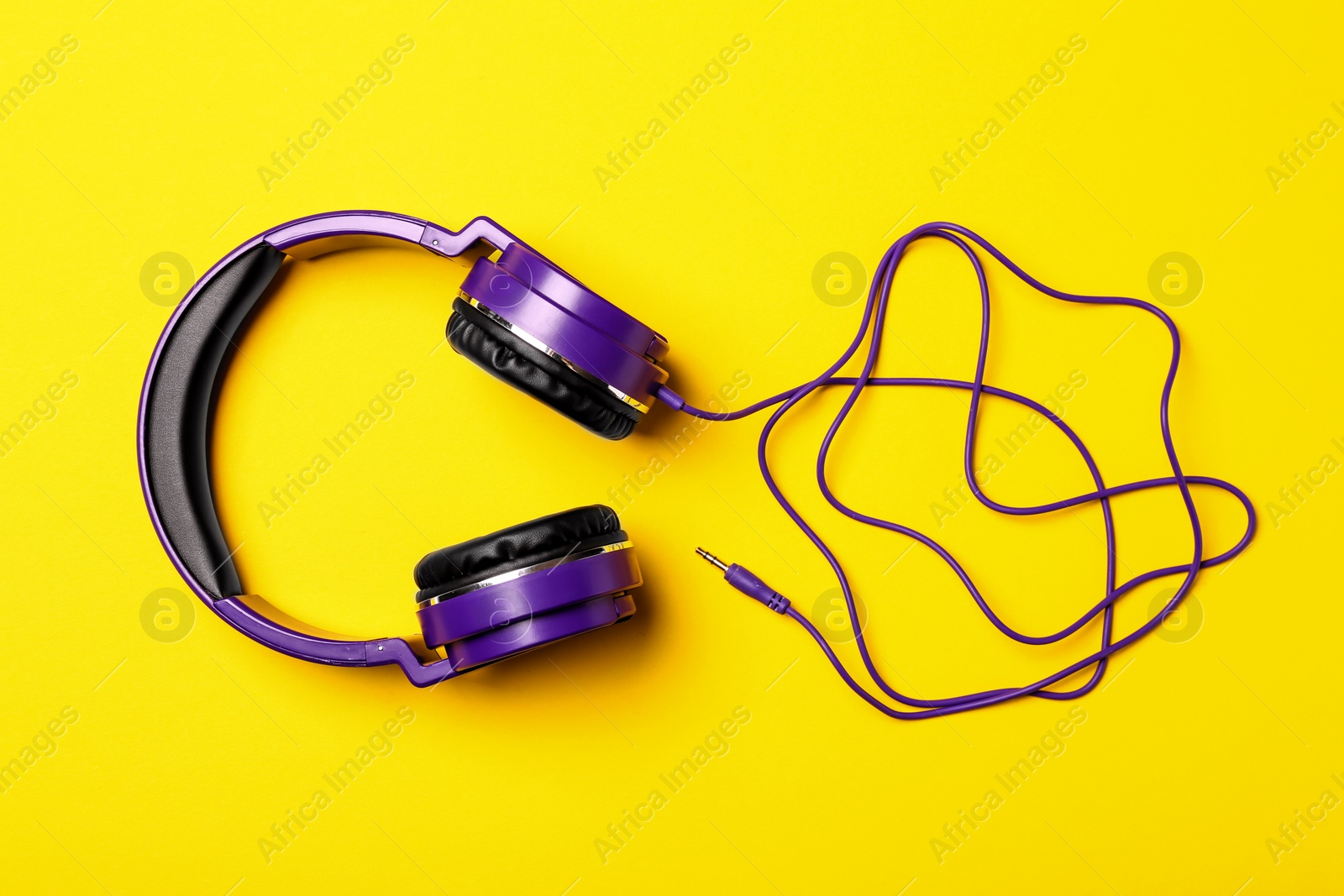 Photo of Stylish modern headphones on color background, top view