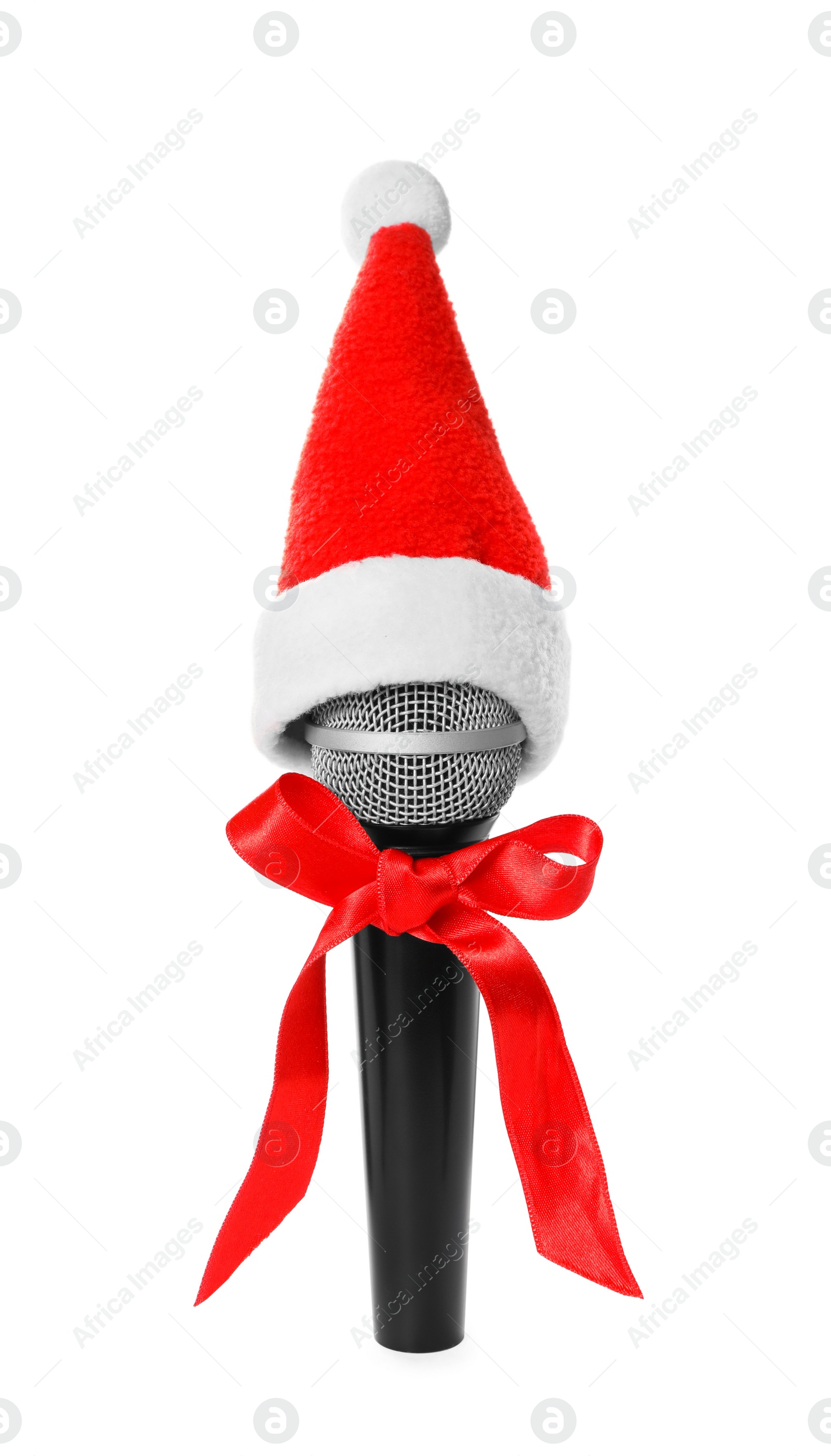 Photo of Microphone with Santa hat and red bow on white background. Christmas music