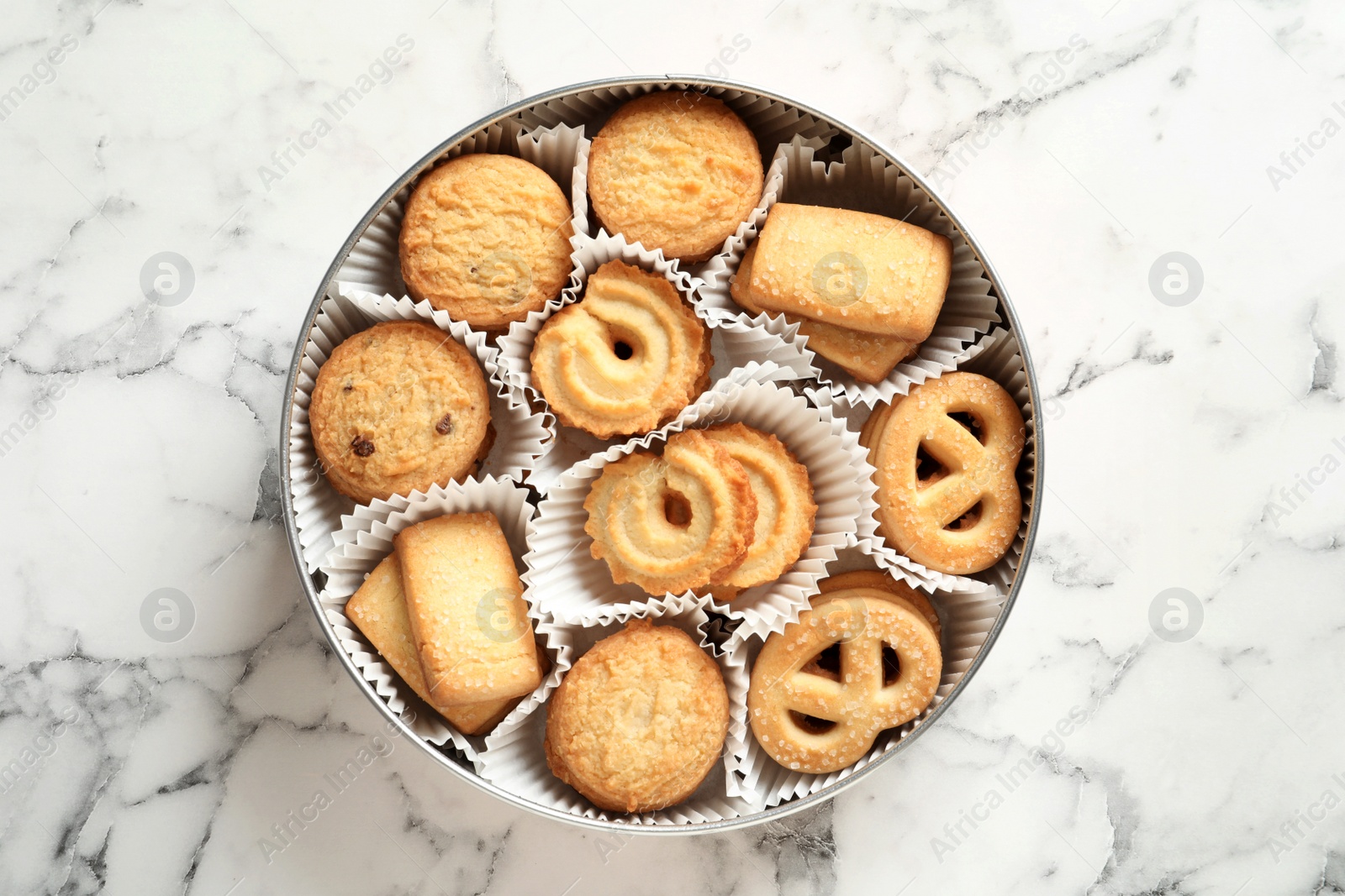 Photo of Tin box with Danish butter cookies on marble table, top view