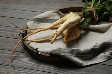 Photo of Tasty fresh ripe parsnips on grey wooden table
