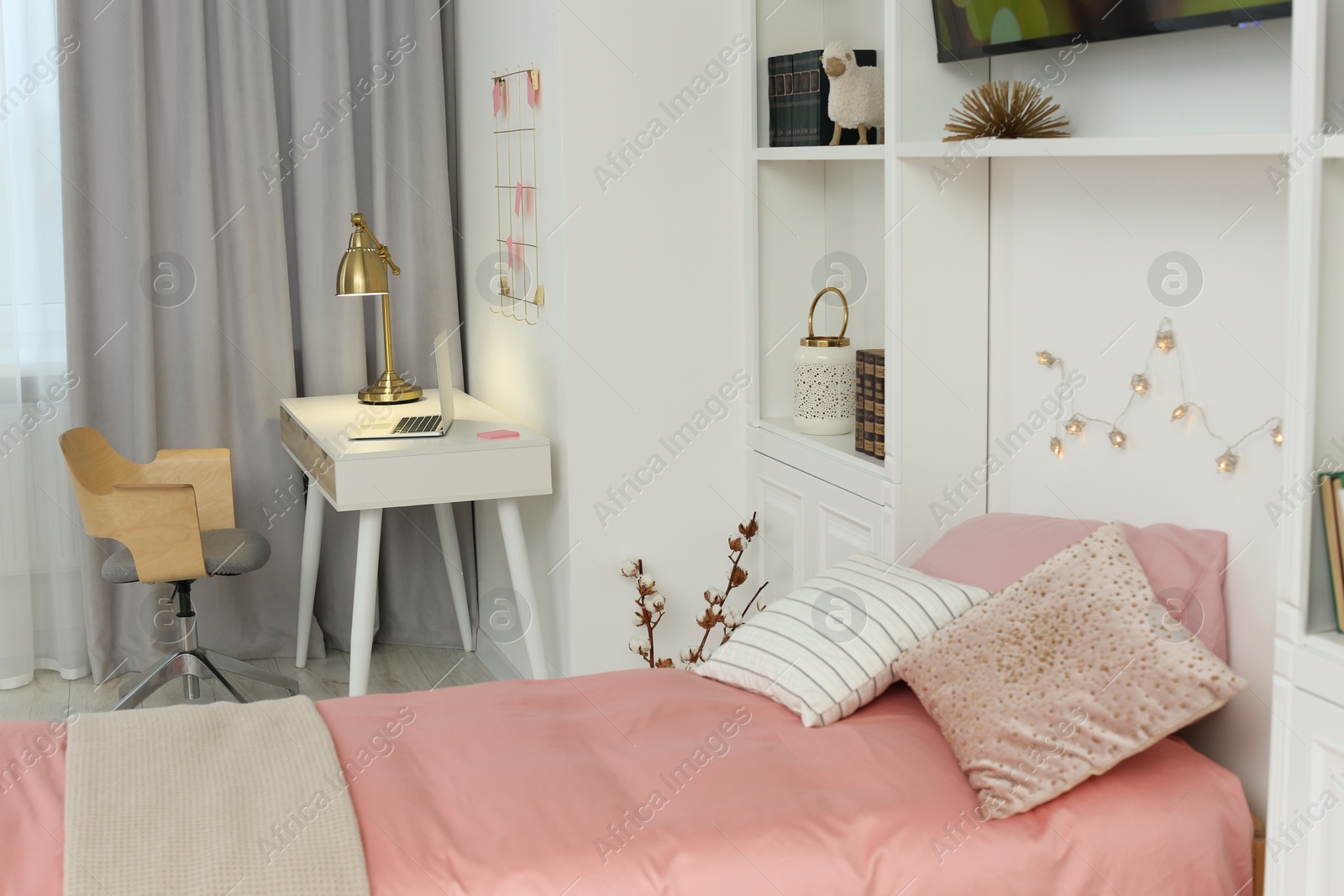 Photo of Stylish teenager's room interior with comfortable bed, workplace and modern TV set