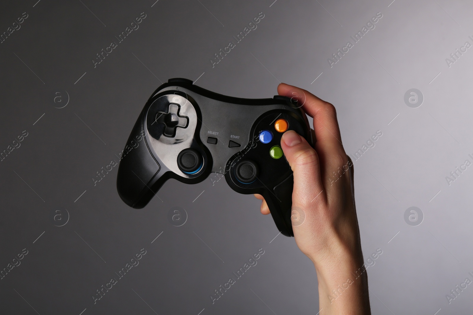 Photo of Woman with game controller on grey background, closeup