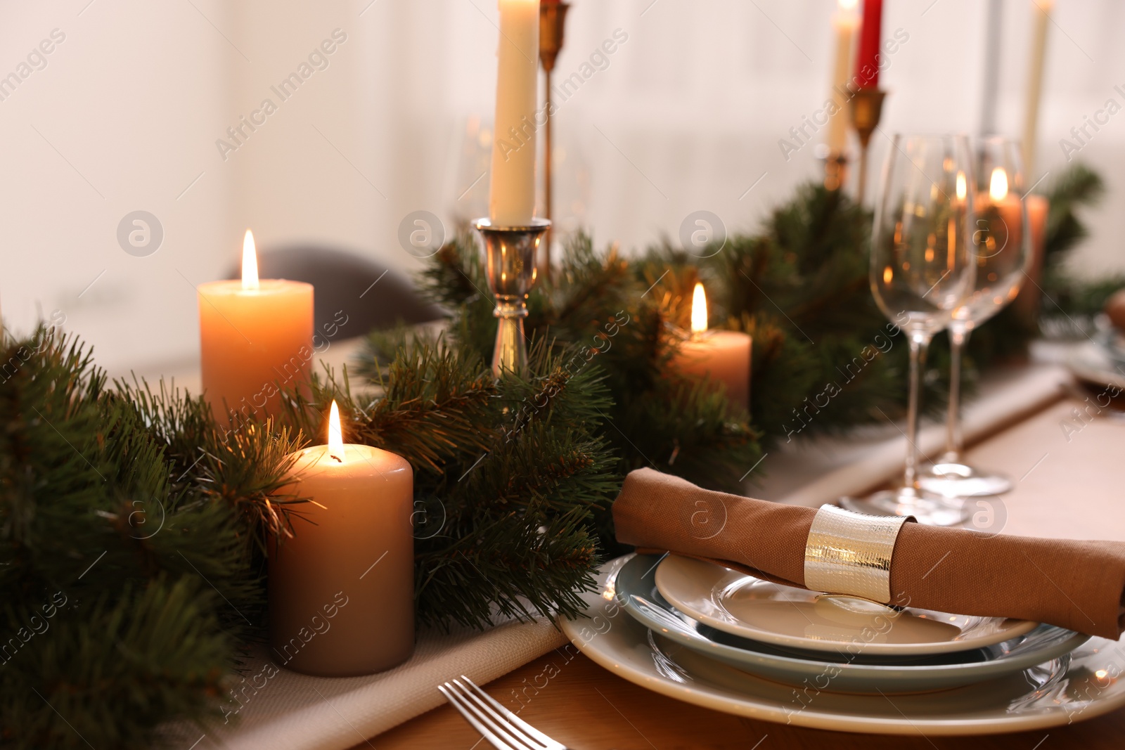 Photo of Luxury place setting with beautiful festive decor for Christmas dinner on wooden table