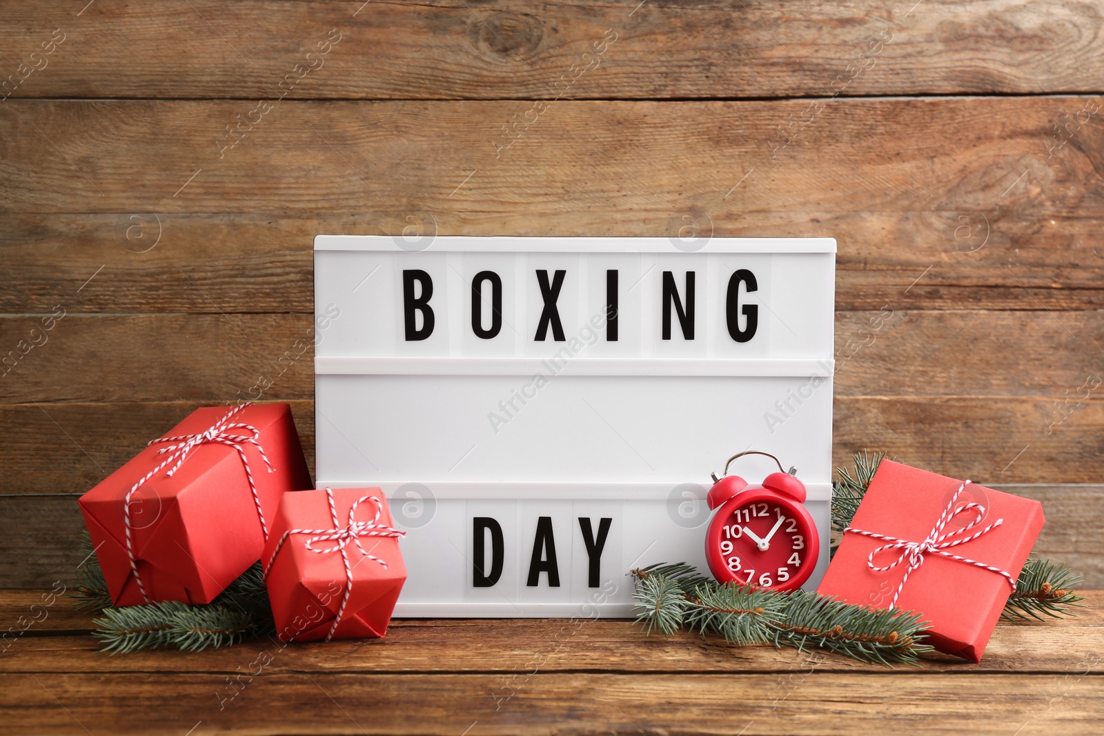 Photo of Composition with Boxing Day sign and Christmas gifts on wooden table