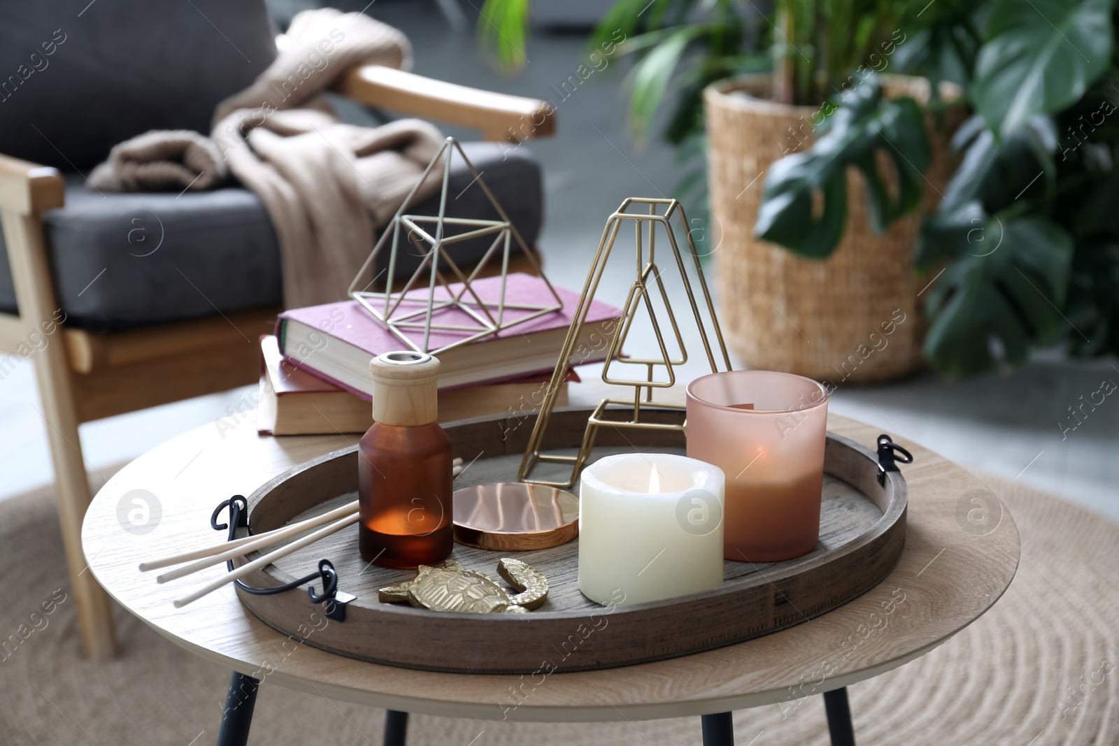 Photo of Wooden tray with decorations on table in room