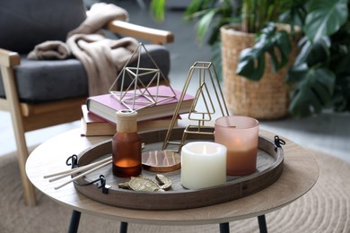 Wooden tray with decorations on table in room