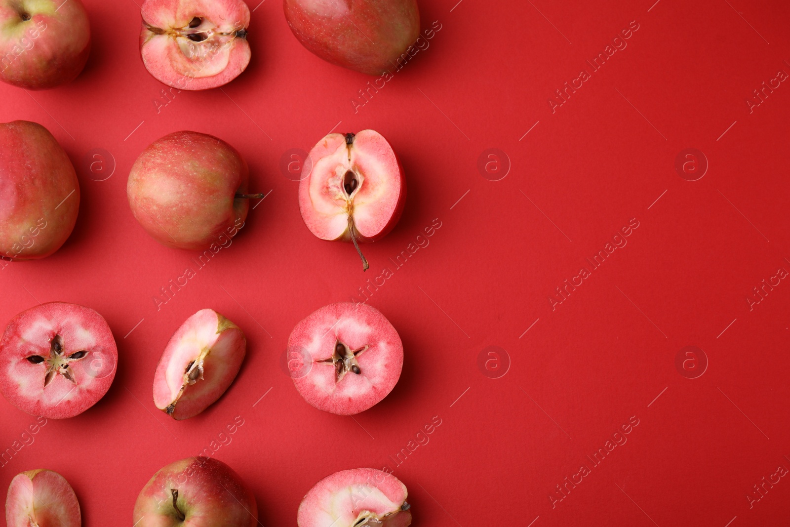 Photo of Tasty apples with red pulp on color background, flat lay. Space for text