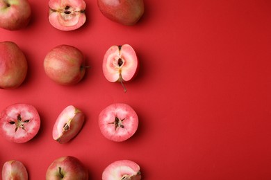 Tasty apples with red pulp on color background, flat lay. Space for text