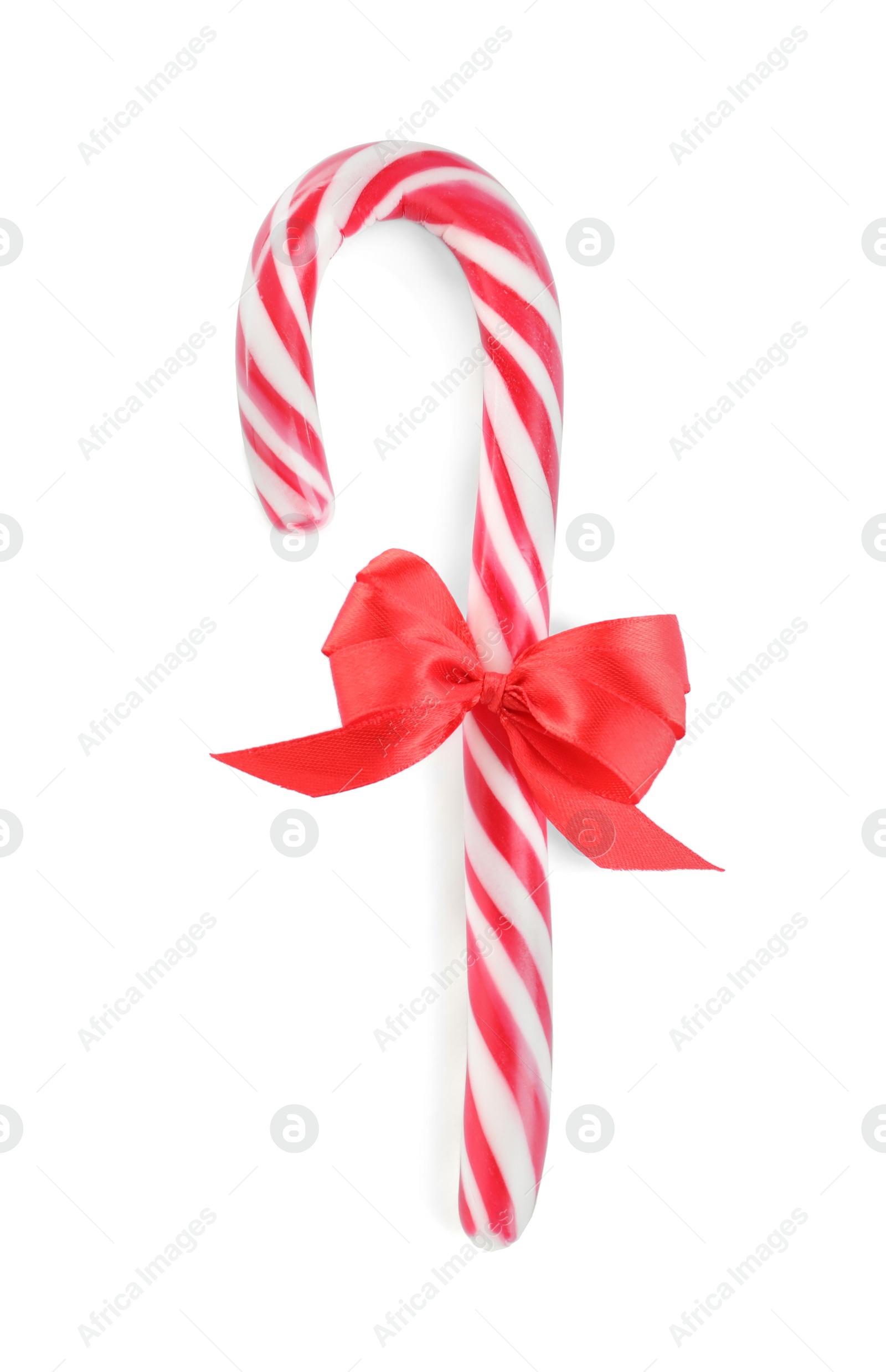 Photo of Sweet Christmas candy cane with red bow isolated on white, top view
