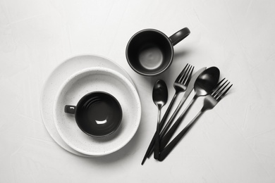 Photo of Flat lay composition with dishware and cutlery on white table