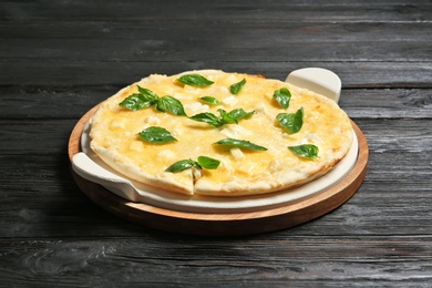 Photo of Fresh tasty homemade pizza on wooden table