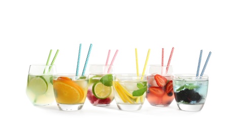 Photo of Glasses with tasty lemonades on white background