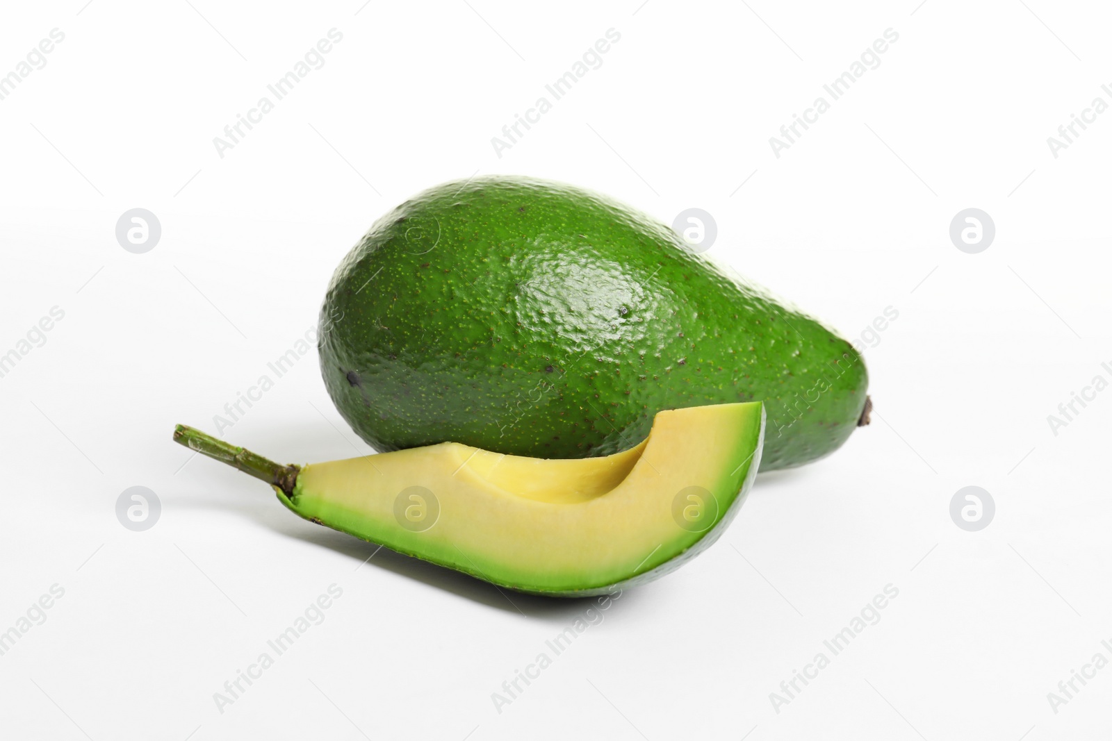 Photo of Ripe fresh avocados on white background