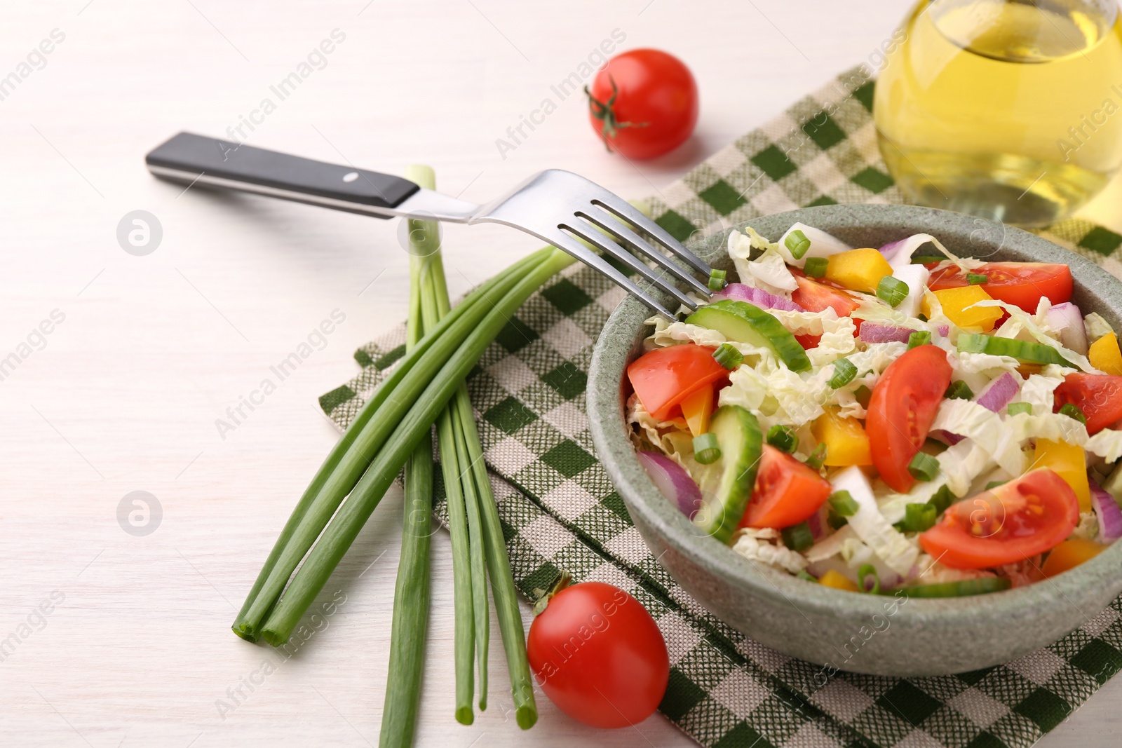 Photo of Tasty salad with Chinese cabbage served on white wooden table. Space for text