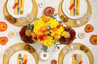 Photo of Autumn table setting with floral decor and pumpkins, flat lay