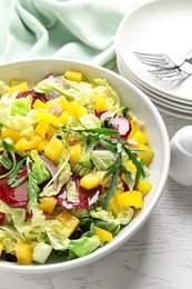 Bowl with tasty beets salad on table, closeup