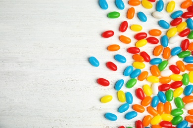 Photo of Flat lay composition with jelly beans on light background. Space for text