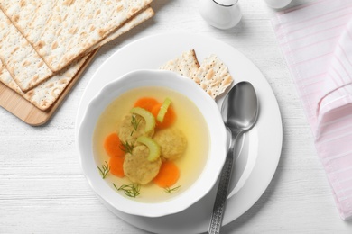 Flat lay composition with Jewish matzoh balls soup on white wooden table