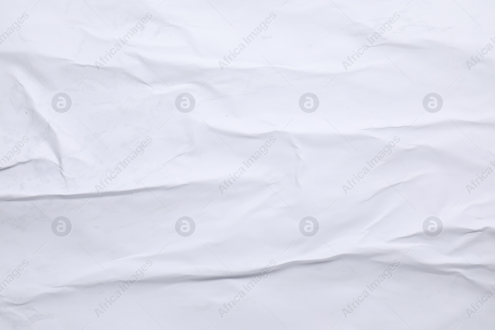 Photo of White crumpled sheet of paper as background, top view. Wall poster