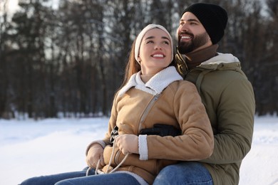 Photo of Portrait of happy young couple outdoors on winter day