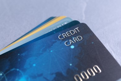 Photo of Many credit cards on grey table, closeup