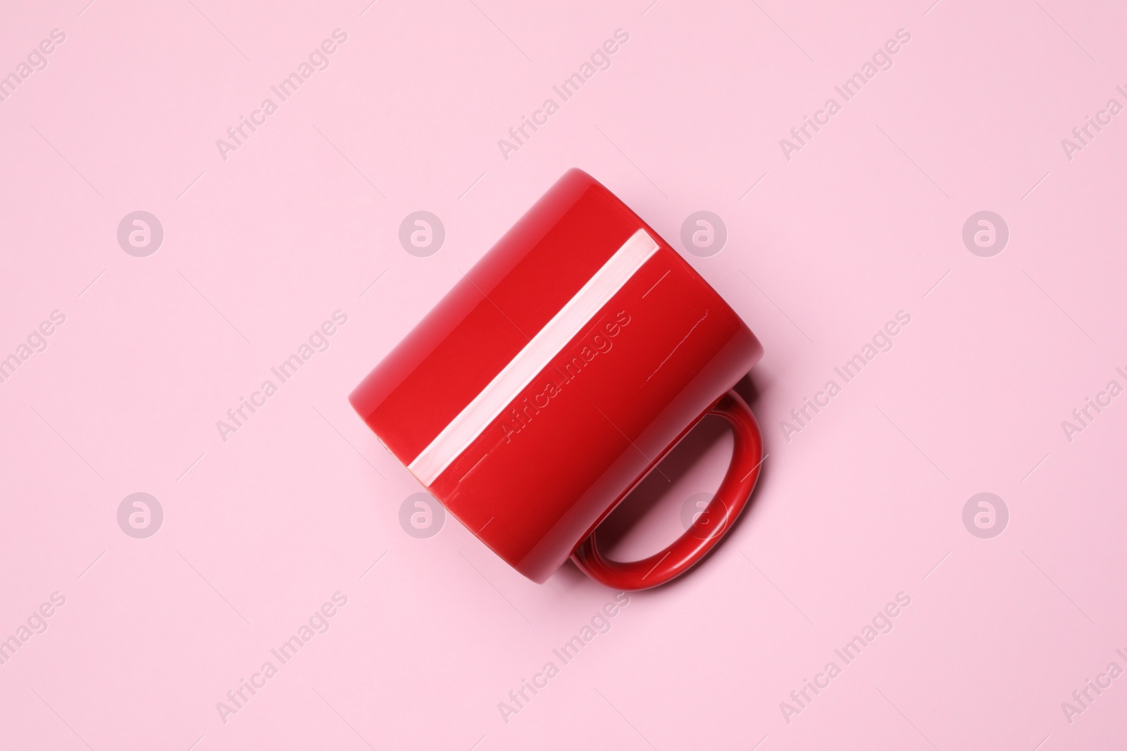 Red ceramic mug on pink background, top view Photo of Red ceramic mug on pink background, top view