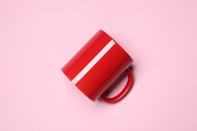 Photo of Red ceramic mug on pink background, top view