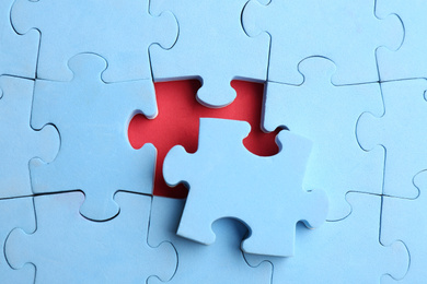 Photo of Light blue puzzle on red background, top view. Career promotion concept