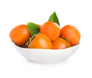 Photo of Bowl with delicious persimmons and green leaves  isolated on white