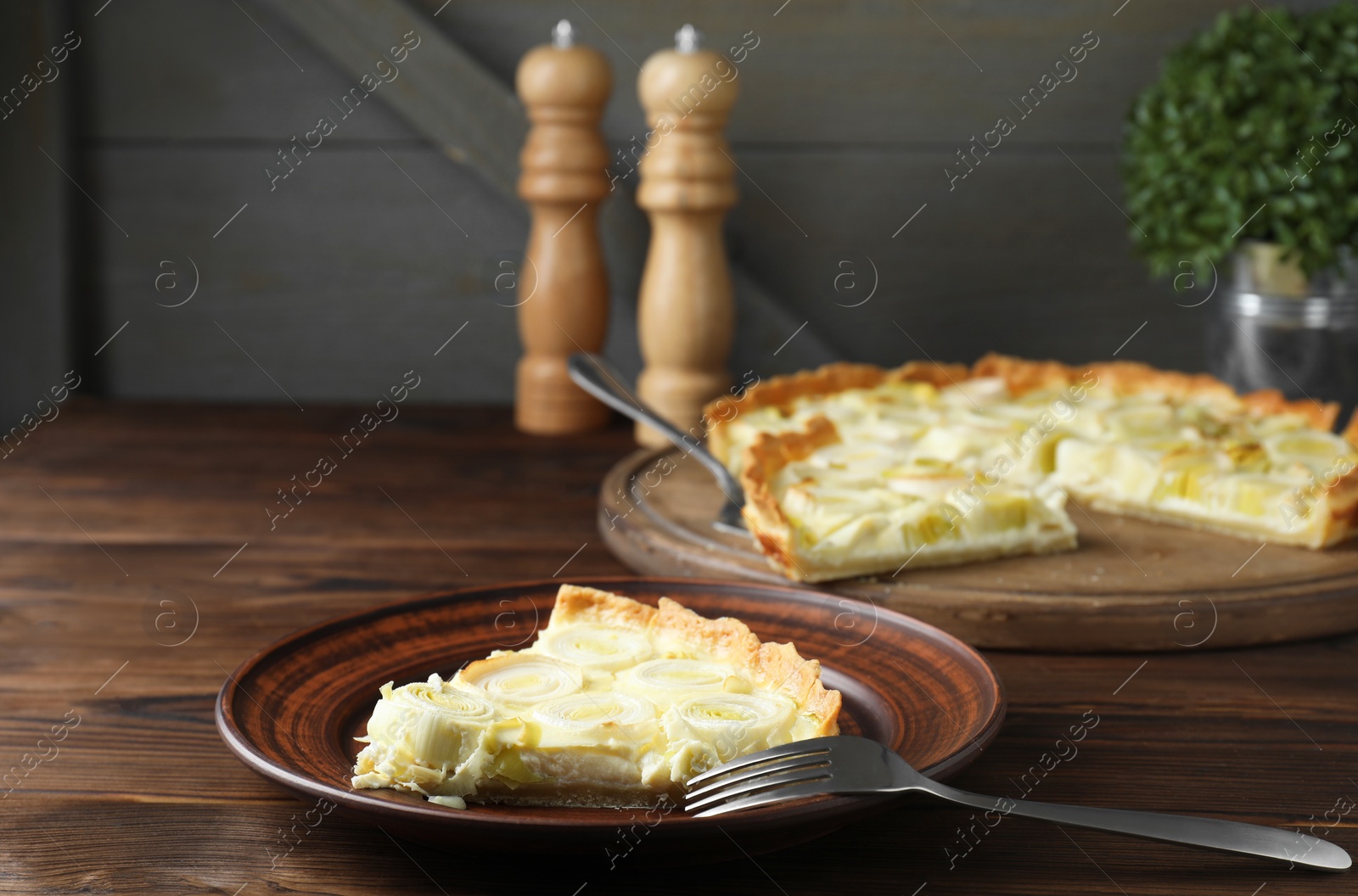 Photo of Tasty leek pie served on wooden table