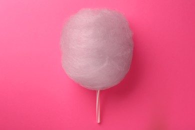 Photo of One sweet cotton candy on pink background, top view