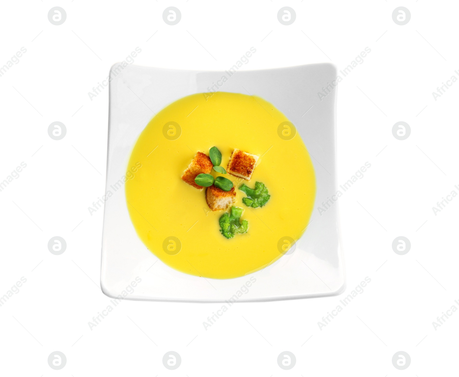 Photo of Bowl of cheese cream soup with broccoli, microgreens and croutons on white background, top view