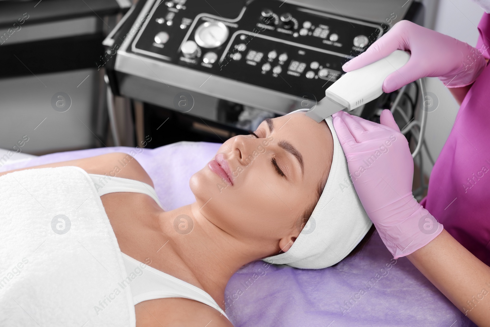 Photo of Young woman undergoing cosmetic procedure in beauty salon. Microcurrent therapy