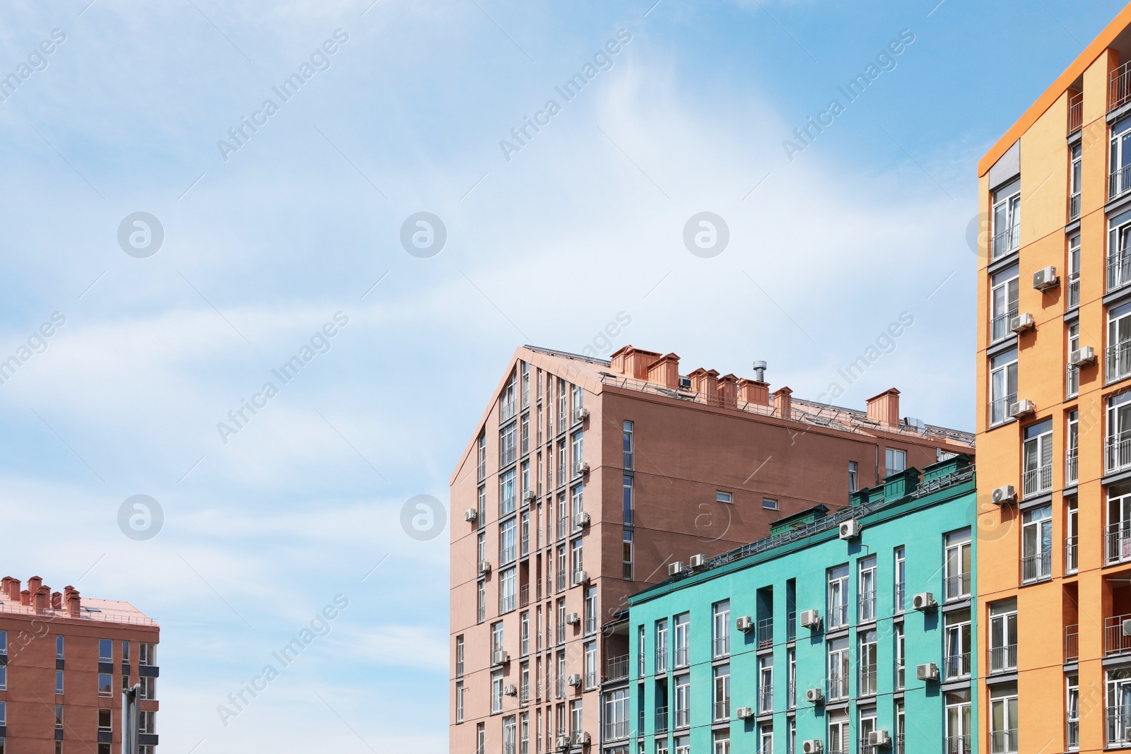 Photo of Colorful modern buildings with windows against sky. Urban architecture