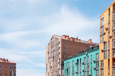 Photo of Colorful modern buildings with windows against sky. Urban architecture