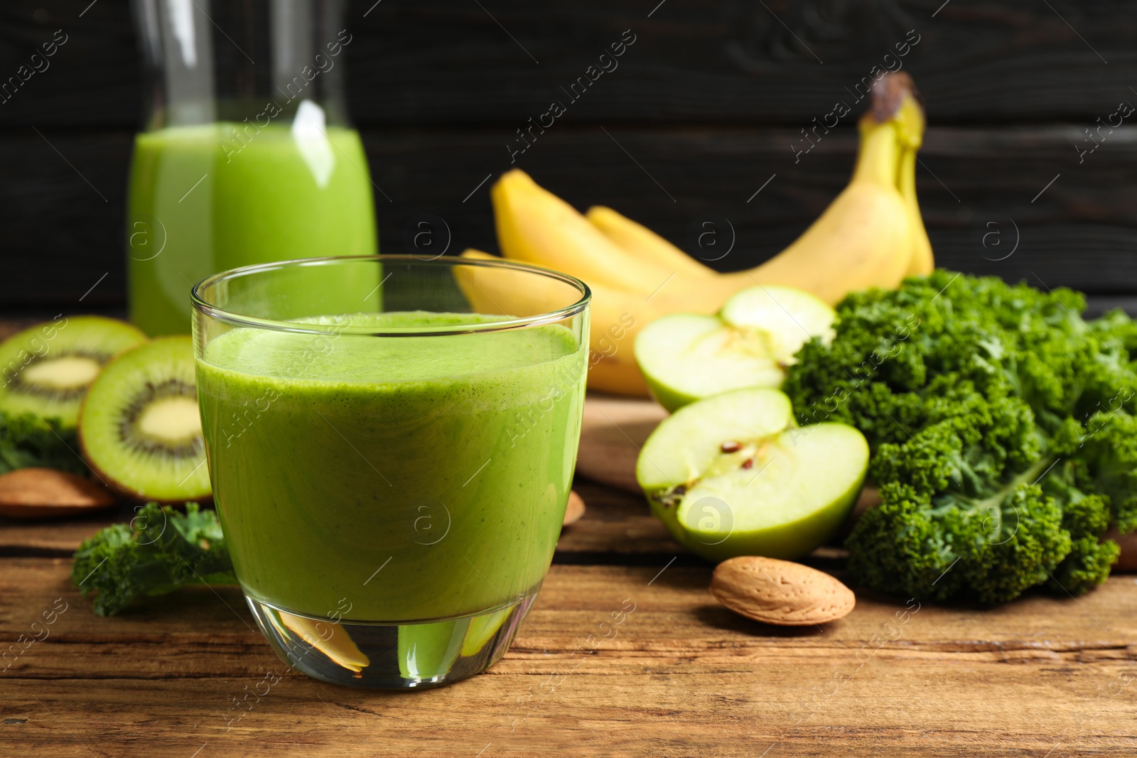 Photo of Tasty fresh kale smoothie on wooden table