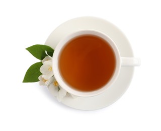 Cup of aromatic jasmine tea and fresh flowers on white background, top view