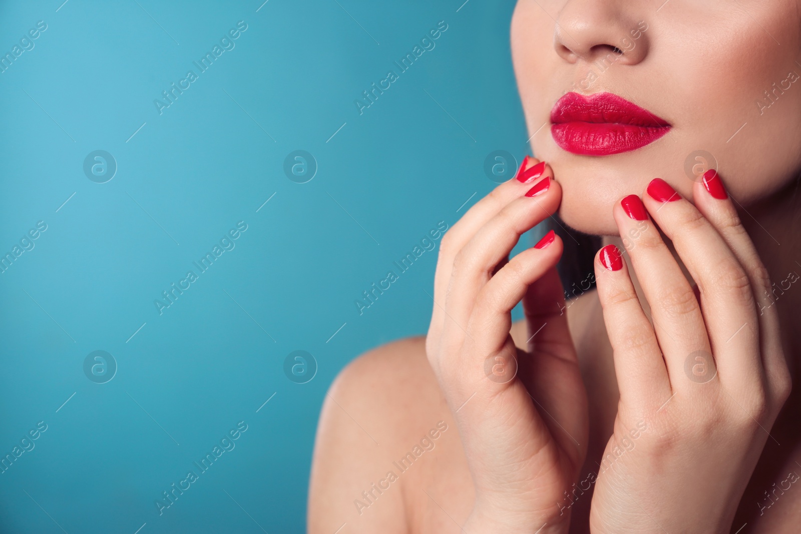 Photo of Beautiful woman with stylish nail polish on color background, closeup. Space for text