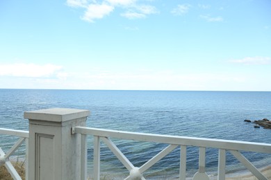 Photo of Simple white balustrade near beautiful tranquil sea