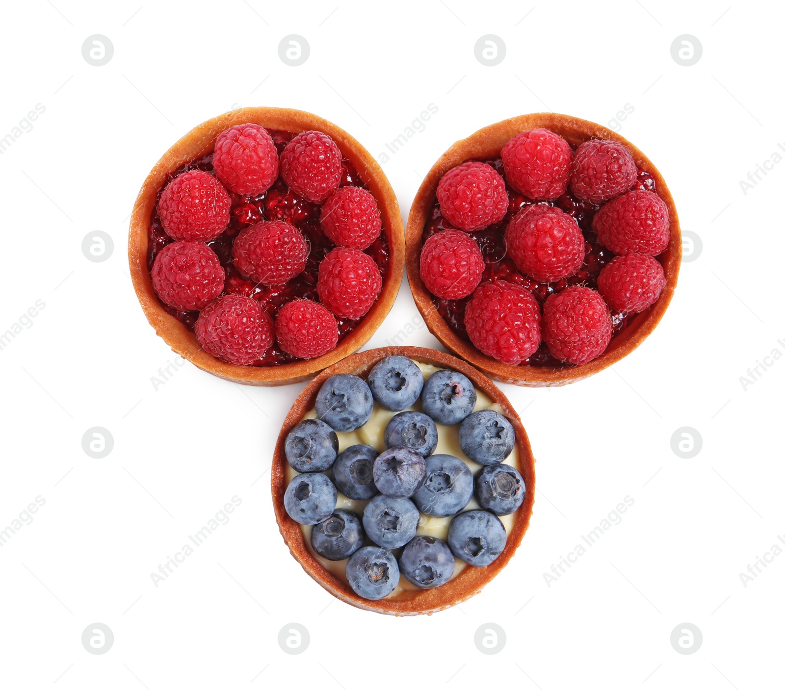 Photo of Tartlets with different fresh berries isolated on white, top view. Delicious dessert