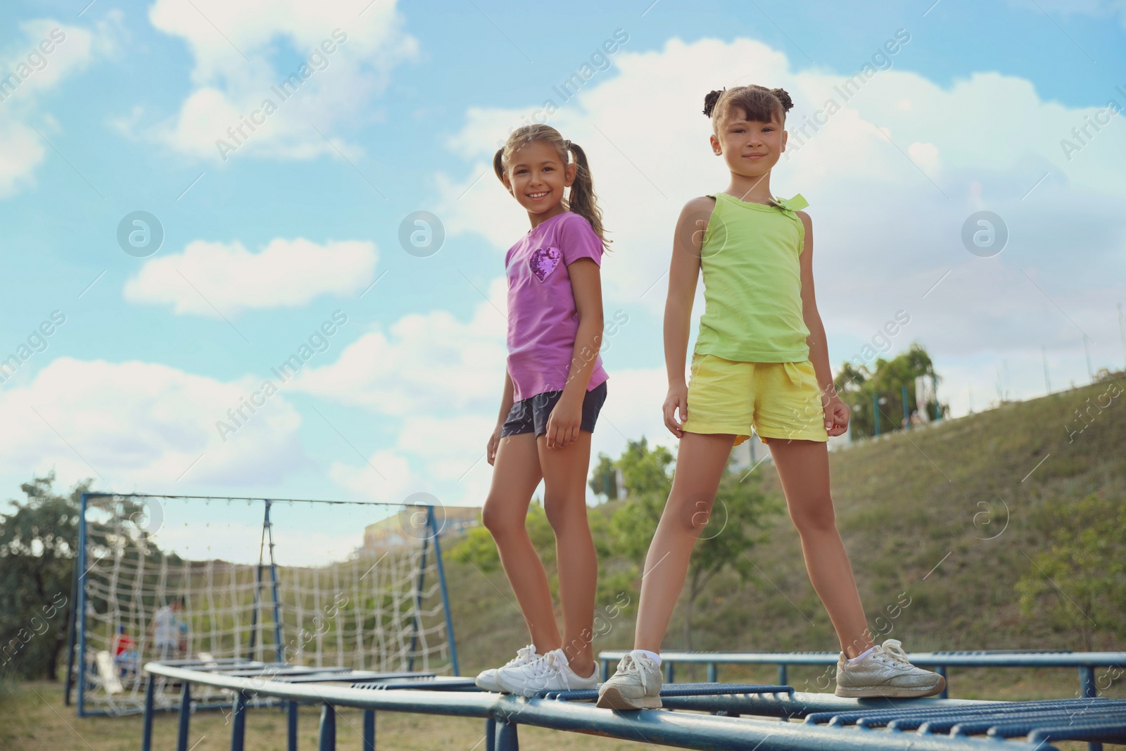 Photo of Cute children on playground climber outdoors. Summer camp