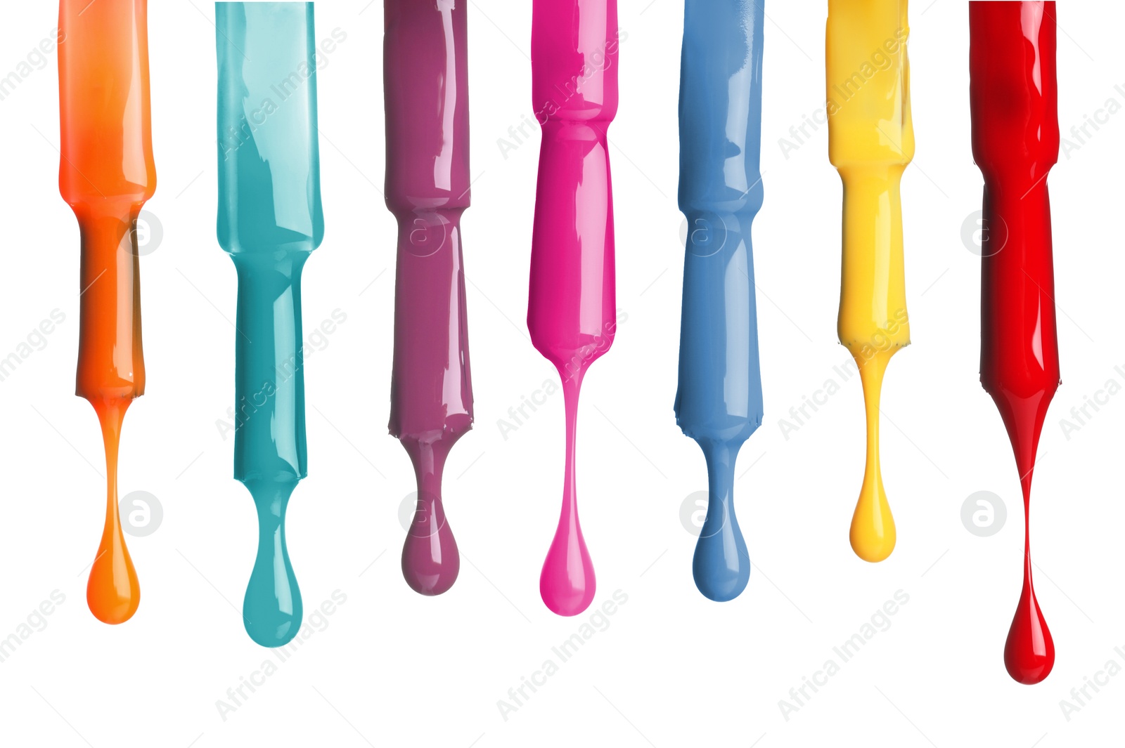 Image of Different color nail polish collection. Set of brushes with dripping liquid isolated on white