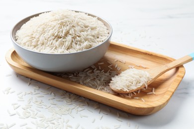 Photo of Uncooked raw basmati rice on white table