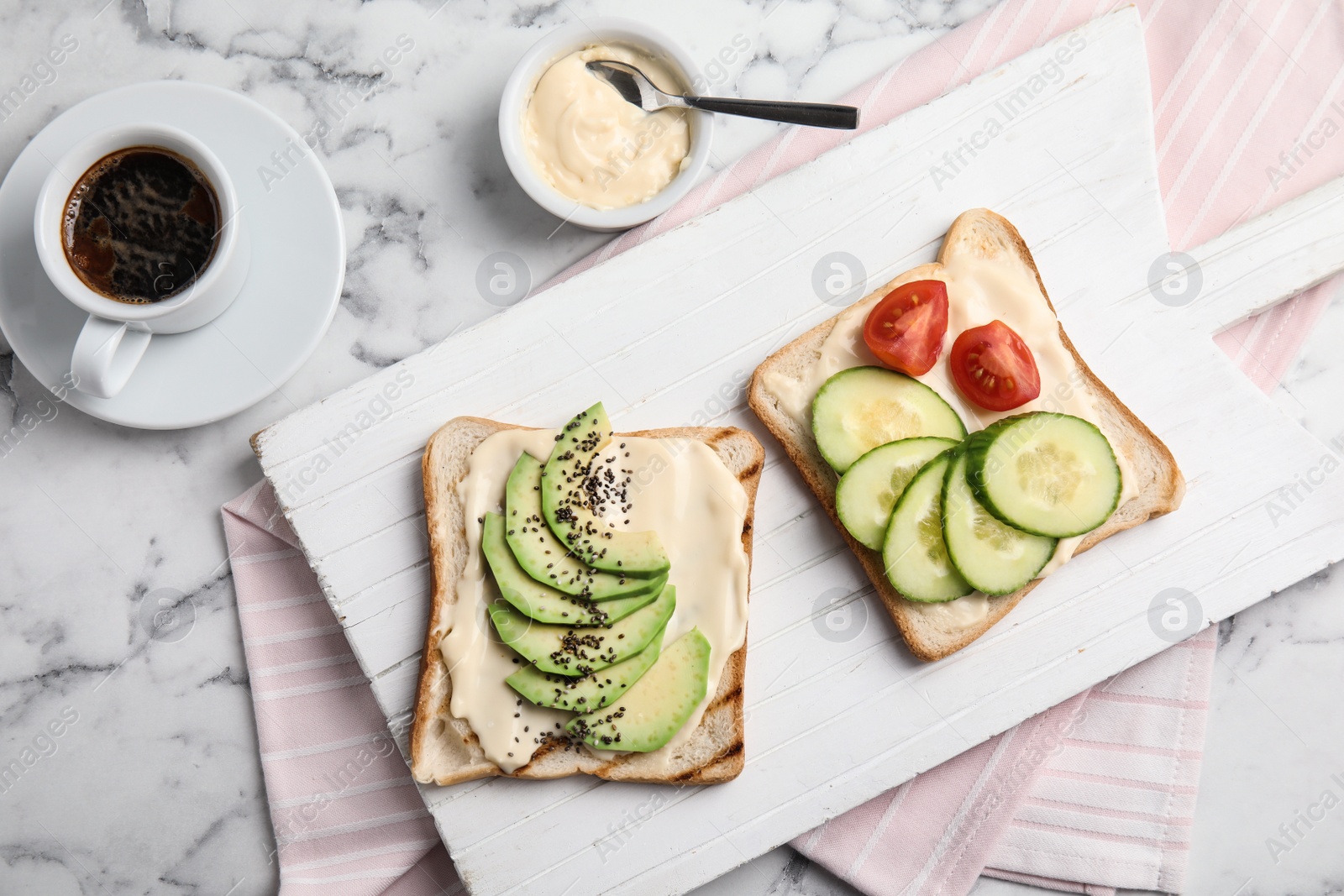 Photo of Slices of bread with different toppings on white marble table, flat lay