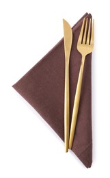 Photo of Brown napkin with golden fork and knife isolated on white, top view. Cutlery set