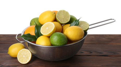 Photo of Metal colander with citrus fruits on wooden table against white background