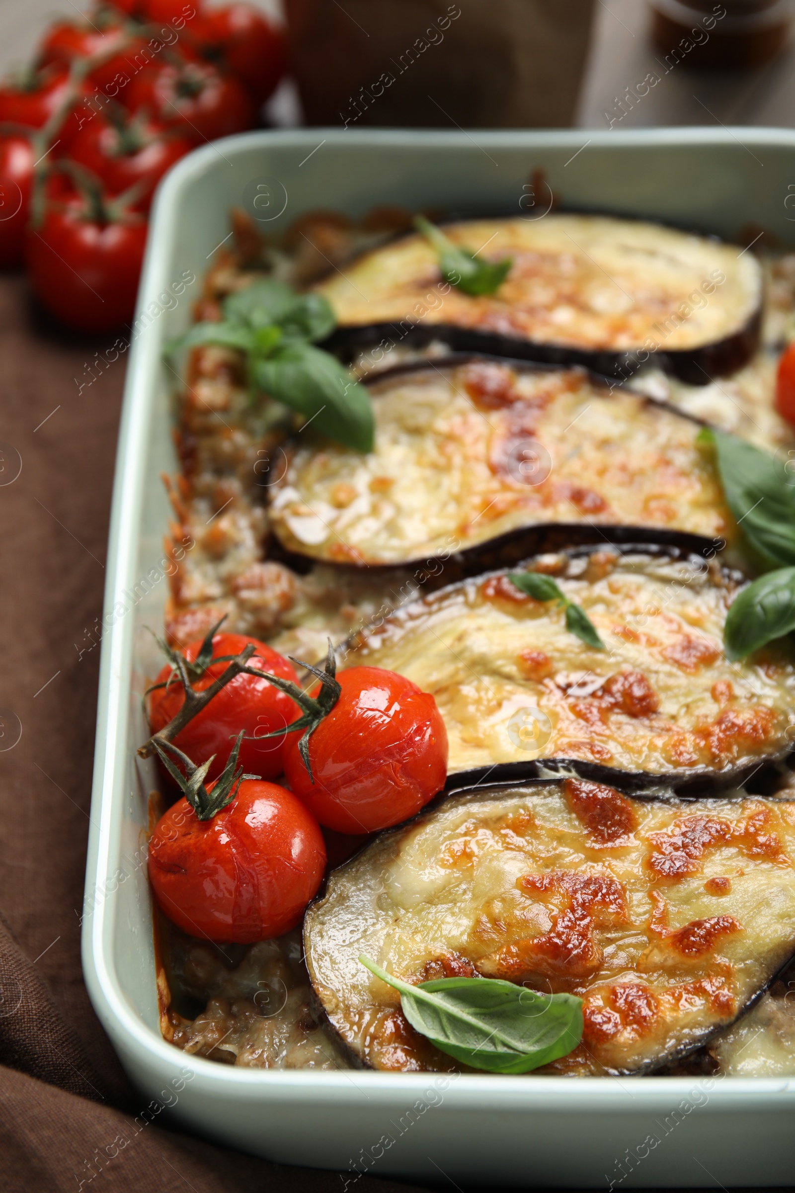 Photo of Delicious eggplant lasagna in baking dish on table, closeup