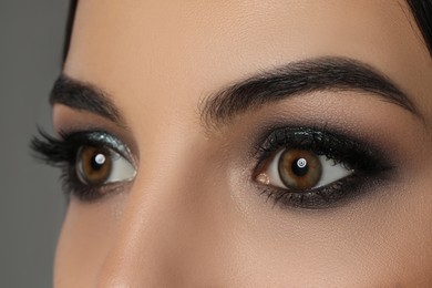 Young woman with evening makeup, closeup. Eye shadow product